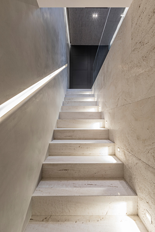Photo of a modern marble straight staircase in Milan with marble risers.