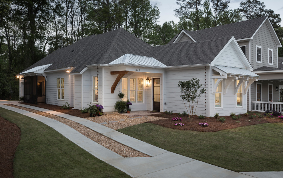 Small country one-storey concrete white house exterior in Atlanta with a mixed roof.