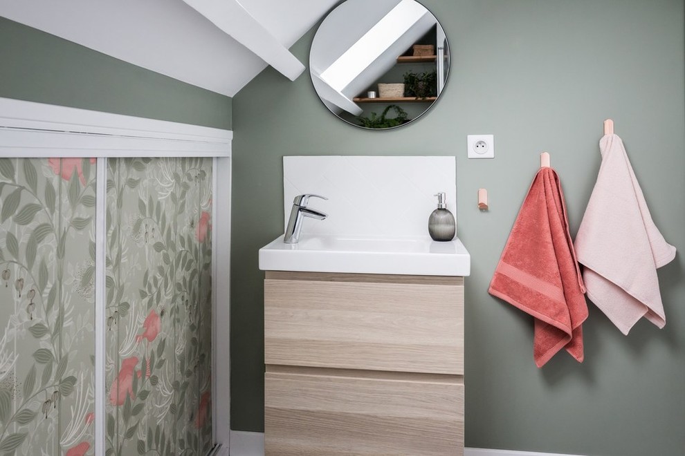 Inspiration for a small contemporary kids bathroom in Paris with flat-panel cabinets, light wood cabinets, an undermount tub, a shower/bathtub combo, a wall-mount toilet, white tile, ceramic tile, green walls, ceramic floors, an integrated sink, grey floor and white benchtops.