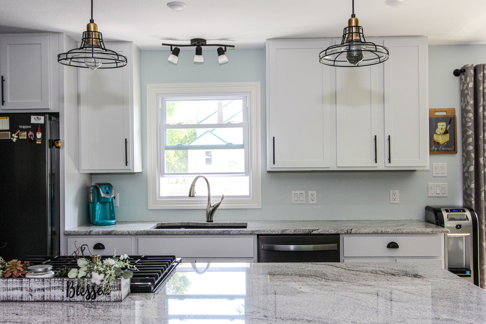 Inspiration for a mid-sized transitional single-wall laminate floor and brown floor open concept kitchen remodel in Minneapolis with an undermount sink, shaker cabinets, gray cabinets, granite countertops, stainless steel appliances, an island and gray countertops