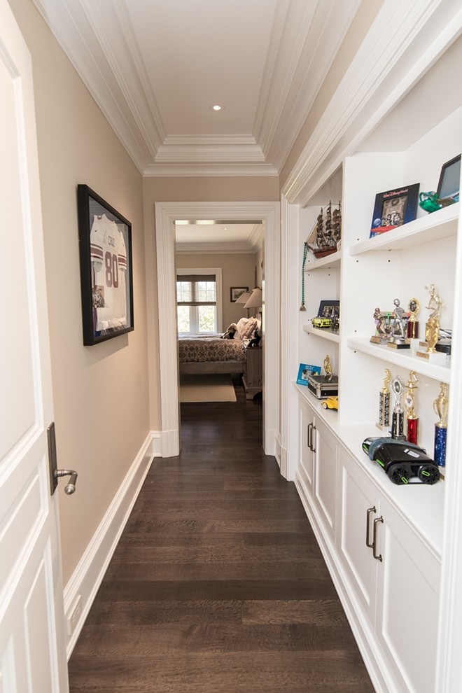 This is an example of a mid-sized traditional hallway in New York with white walls and dark hardwood floors.