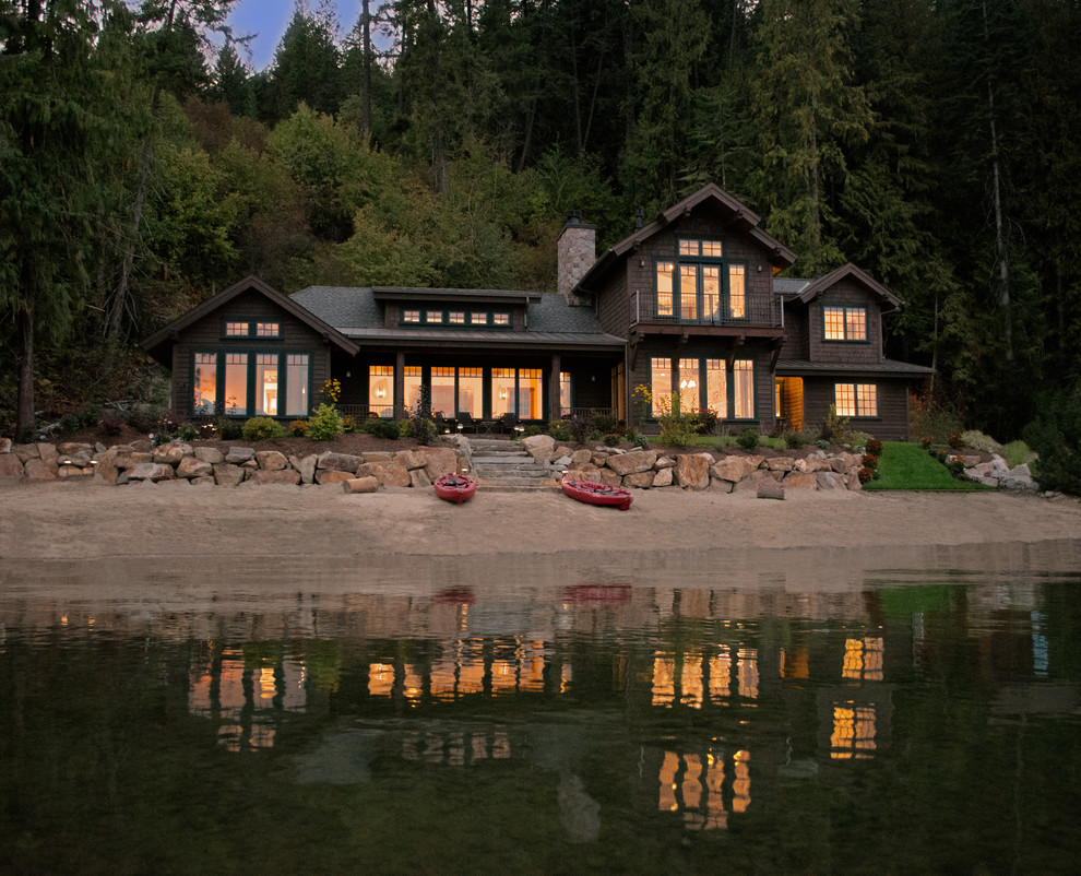 This is an example of a mid-sized country two-storey brown exterior in Seattle with wood siding and a gable roof.