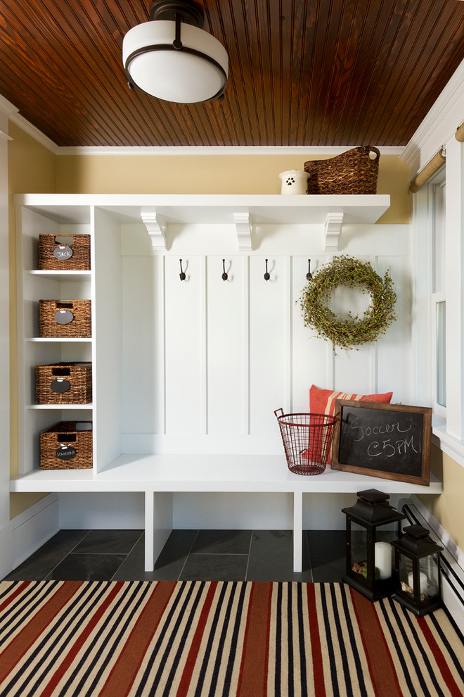 Design ideas for an arts and crafts mudroom in Minneapolis with yellow walls.