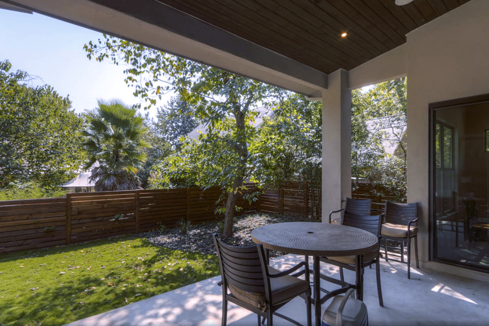 Large trendy backyard concrete patio photo