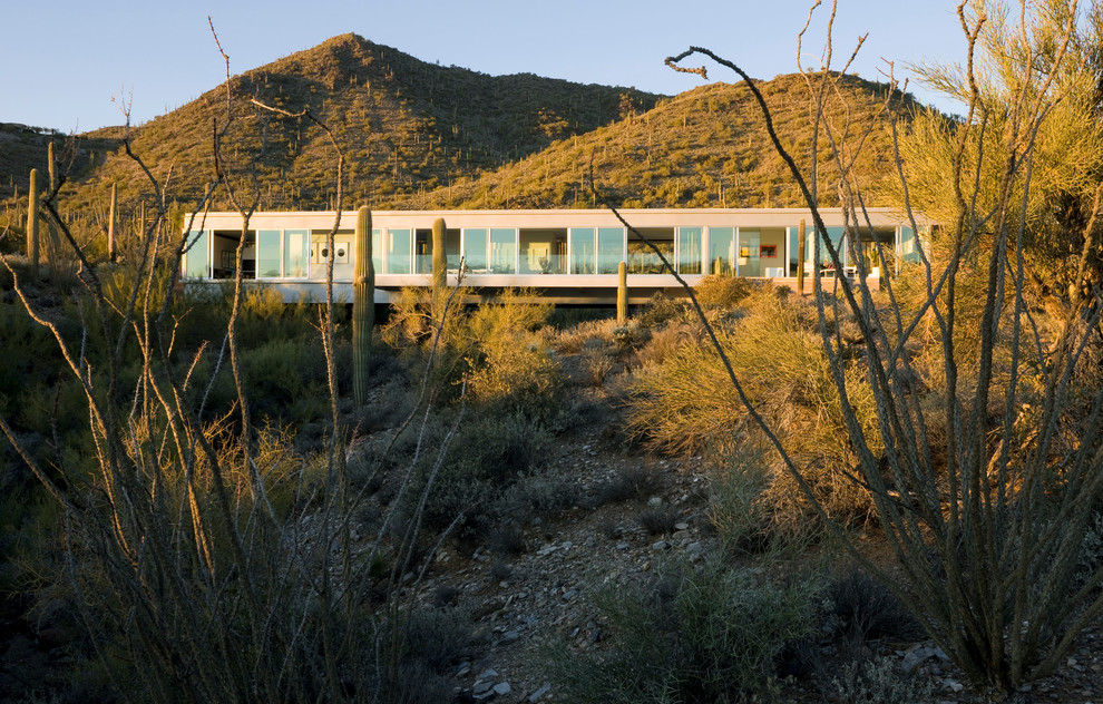 Inspiration for a modern one-storey glass exterior in Phoenix.