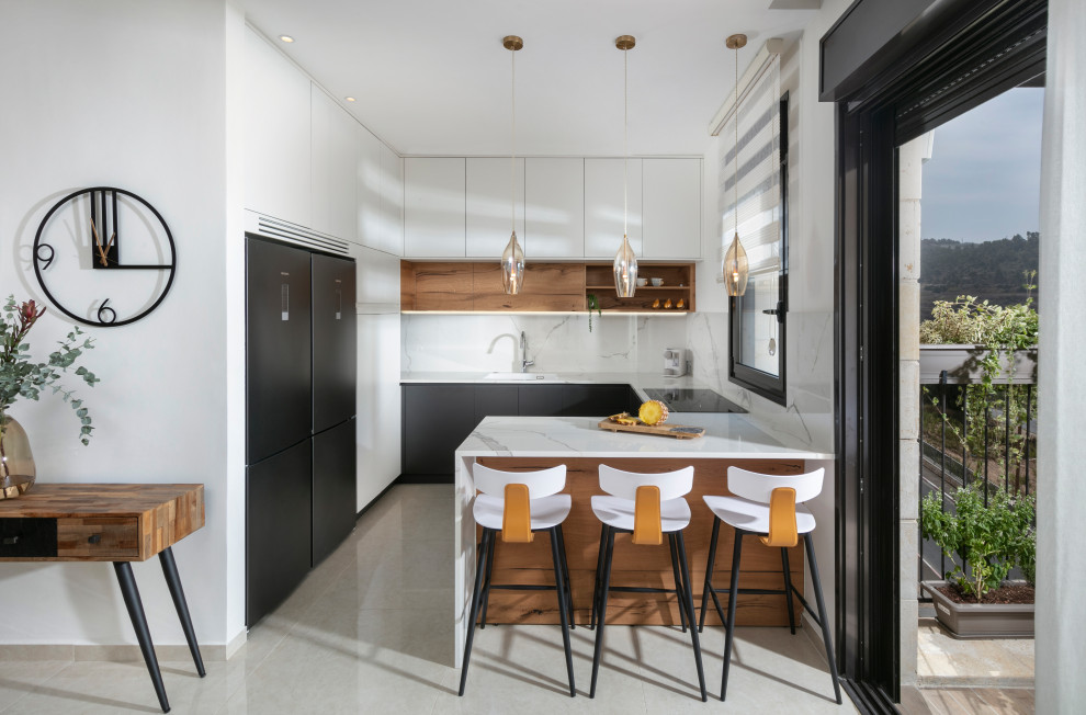 Inspiration for a mid-sized contemporary u-shaped ceramic tile and beige floor open concept kitchen remodel in Tel Aviv with an undermount sink, flat-panel cabinets, white cabinets, quartz countertops, white backsplash, quartz backsplash, black appliances, a peninsula and white countertops