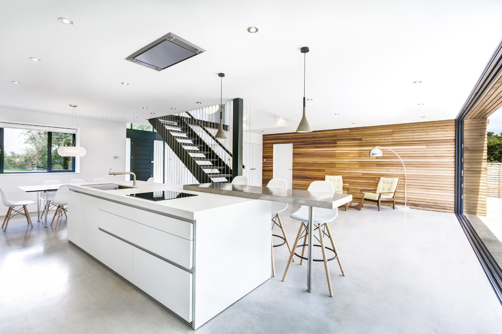 Inspiration for a mid-sized contemporary galley eat-in kitchen in Wiltshire with an integrated sink, flat-panel cabinets, white cabinets, laminate benchtops, stainless steel appliances and with island.