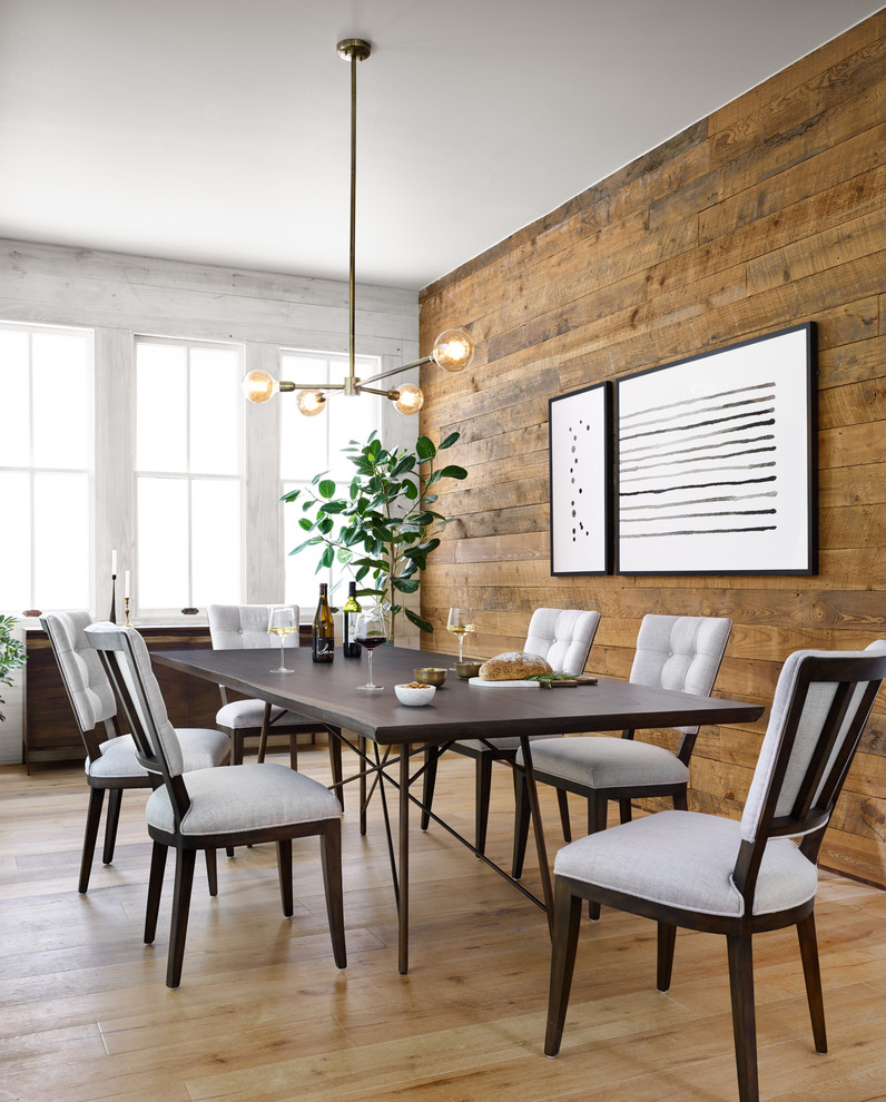 This is an example of a transitional dining room in Dallas with brown walls, medium hardwood floors and brown floor.