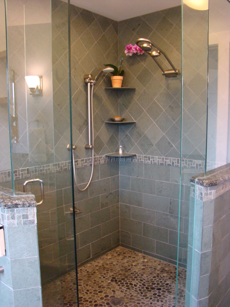 Design ideas for a mid-sized arts and crafts 3/4 bathroom in Portland Maine with an undermount sink, shaker cabinets, medium wood cabinets, granite benchtops, a corner shower, a two-piece toilet, multi-coloured tile, stone tile, white walls and pebble tile floors.