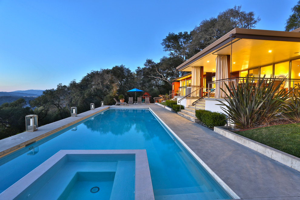 Design ideas for a contemporary backyard rectangular pool in San Francisco with concrete slab.