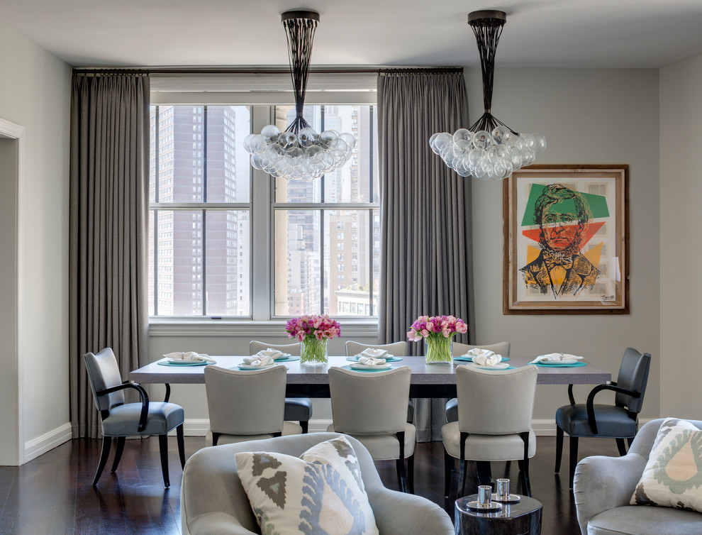 Transitional dining room in New York with grey walls and medium hardwood floors.