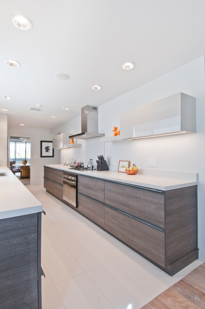 Mid-sized modern galley eat-in kitchen in Los Angeles with an undermount sink, flat-panel cabinets, grey cabinets, quartzite benchtops, red splashback, stainless steel appliances, porcelain floors, no island and turquoise floor.