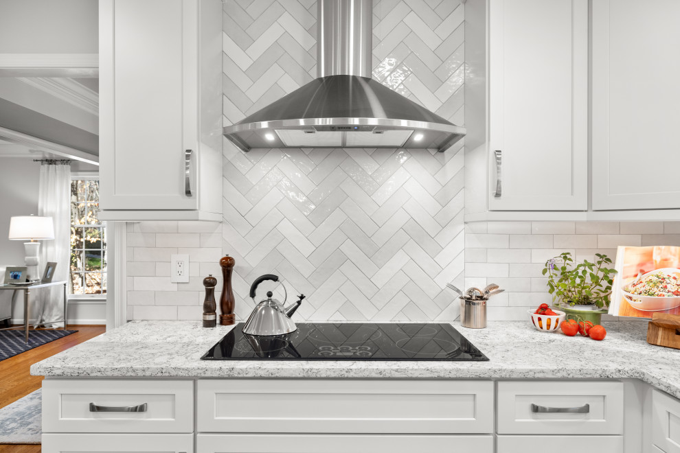 Mid-sized transitional kitchen photo in DC Metro with shaker cabinets, white cabinets, quartz countertops, porcelain backsplash, stainless steel appliances and an island