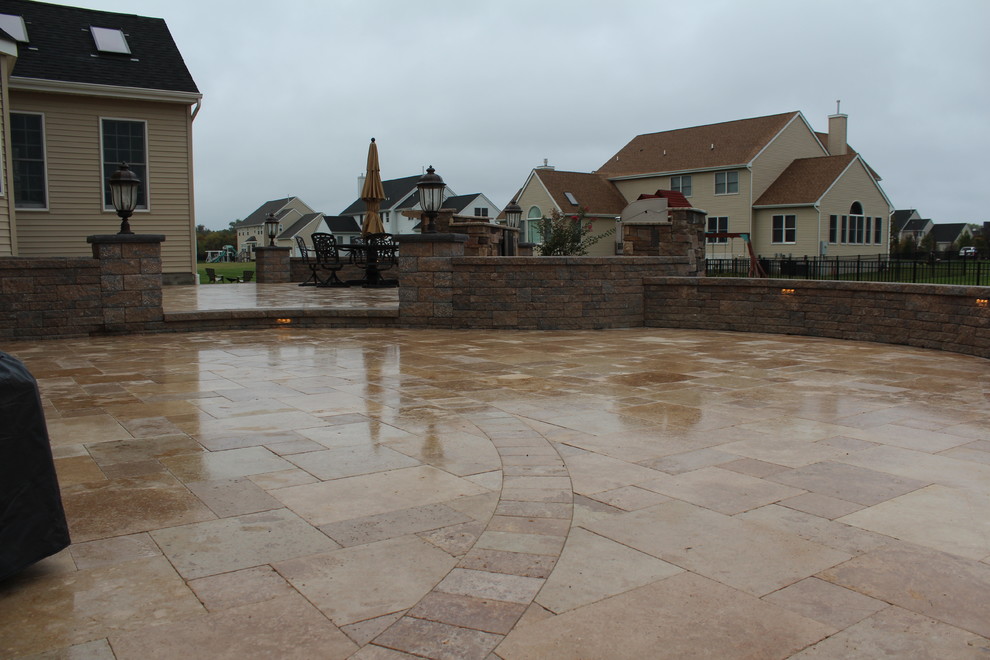 Mid-sized traditional backyard patio in New York with an outdoor kitchen and natural stone pavers.