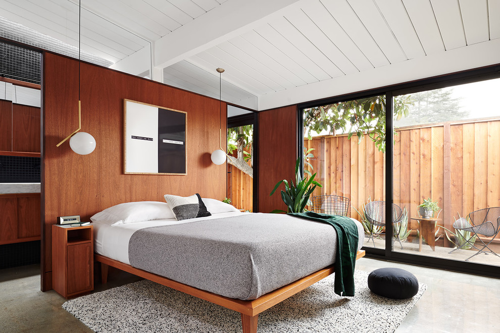 Small contemporary master bedroom in San Francisco with brown walls, concrete floors and grey floor.