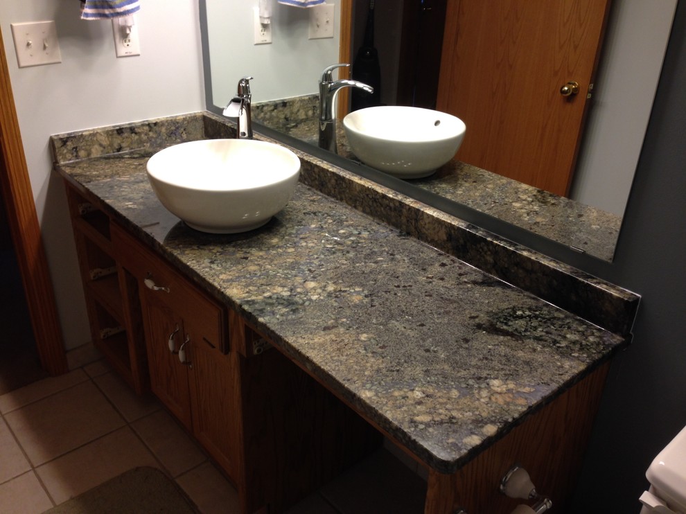 Mid-sized transitional bathroom photo with a vessel sink, recessed-panel cabinets, medium tone wood cabinets and granite countertops