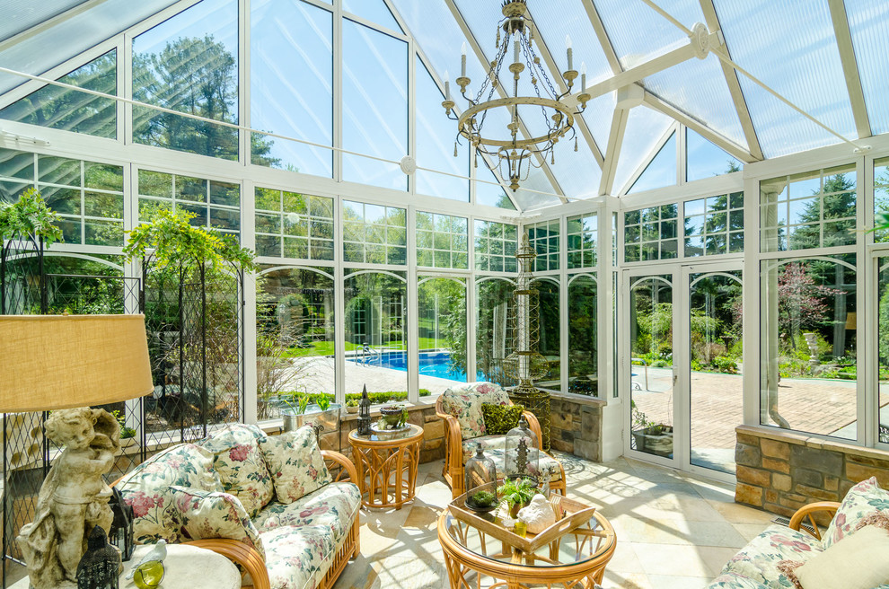 This is an example of a mid-sized traditional sunroom in Minneapolis with travertine floors and a glass ceiling.