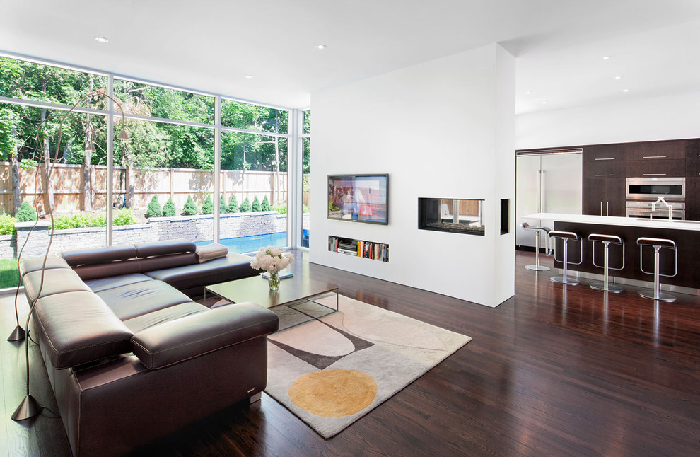 This is an example of a contemporary living room in Ottawa with a two-sided fireplace.