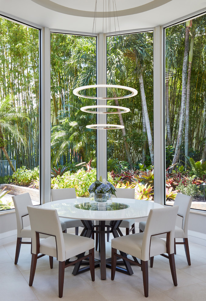 Photo of a contemporary dining room in Miami with beige floor.