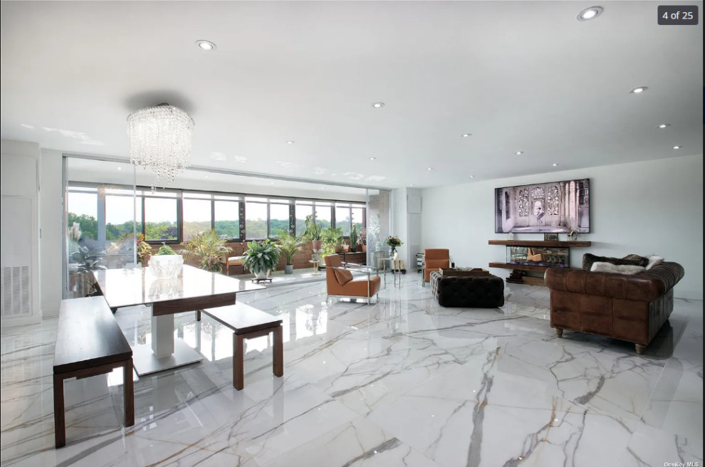 Large modern open concept living room in New York with a home bar, white walls, porcelain floors, a wall-mounted tv and multi-coloured floor.