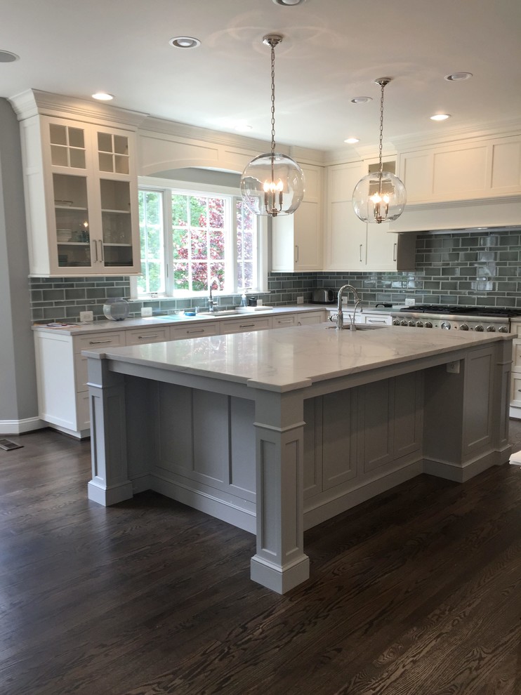 Inspiration for a large modern l-shaped dark wood floor open concept kitchen remodel in Seattle with glass-front cabinets, white cabinets, stainless steel appliances and an island