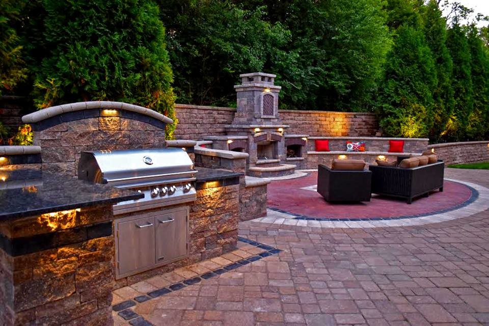 Photo of a large traditional backyard patio in Chicago with a fire feature and brick pavers.
