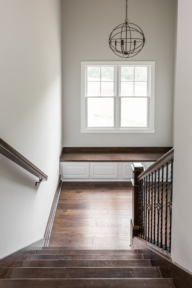 Inspiration for a large arts and crafts wood u-shaped staircase in Indianapolis with wood risers.