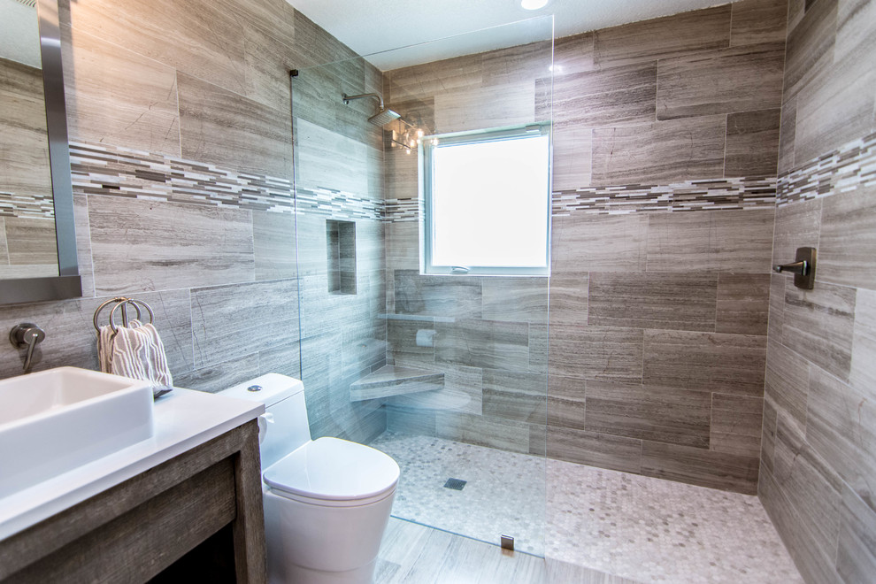 Mid-sized modern bathroom in Tampa with furniture-like cabinets, grey cabinets, an open shower, a one-piece toilet, gray tile, marble, grey walls, marble floors, a vessel sink, quartzite benchtops, grey floor, an open shower and white benchtops.