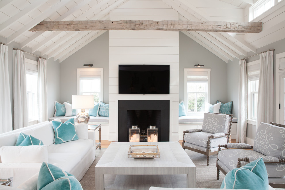 Design ideas for a large beach style open concept living room in Boston with grey walls, light hardwood floors, a standard fireplace and a wall-mounted tv.