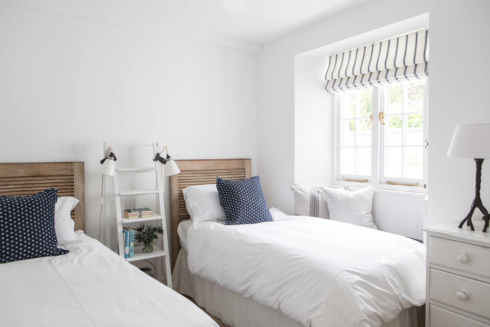 Inspiration for a beach style guest bedroom in London with white walls.