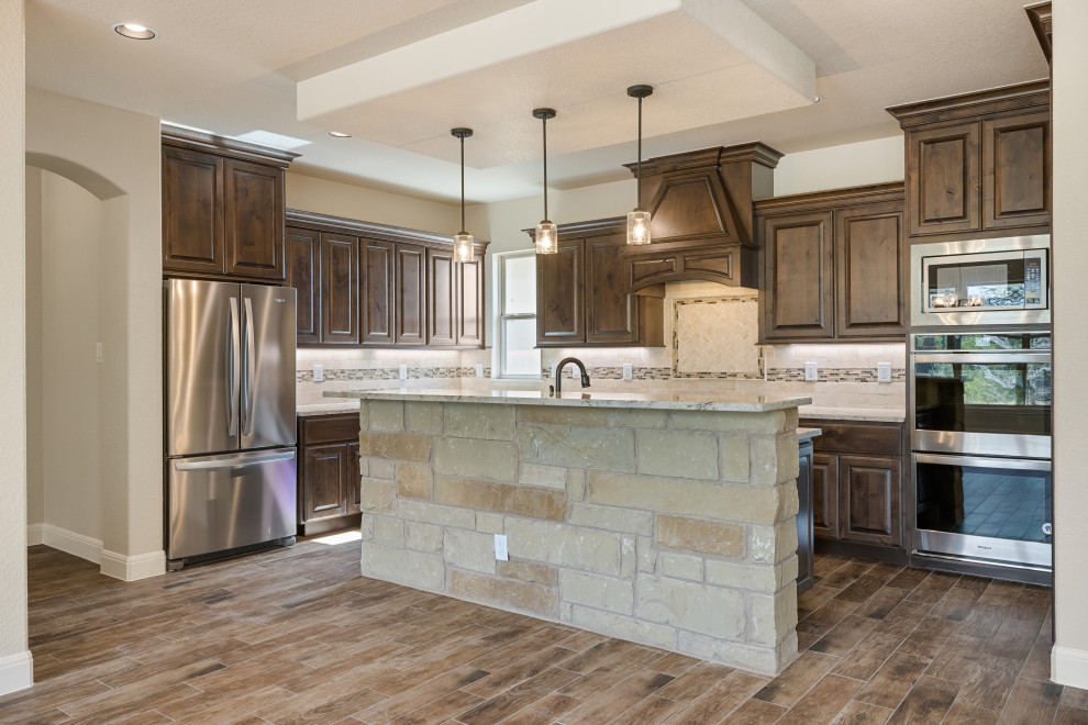 Kitchen - rustic medium tone wood floor kitchen idea in Austin with shaker cabinets, dark wood cabinets, granite countertops, mosaic tile backsplash, stainless steel appliances and an island