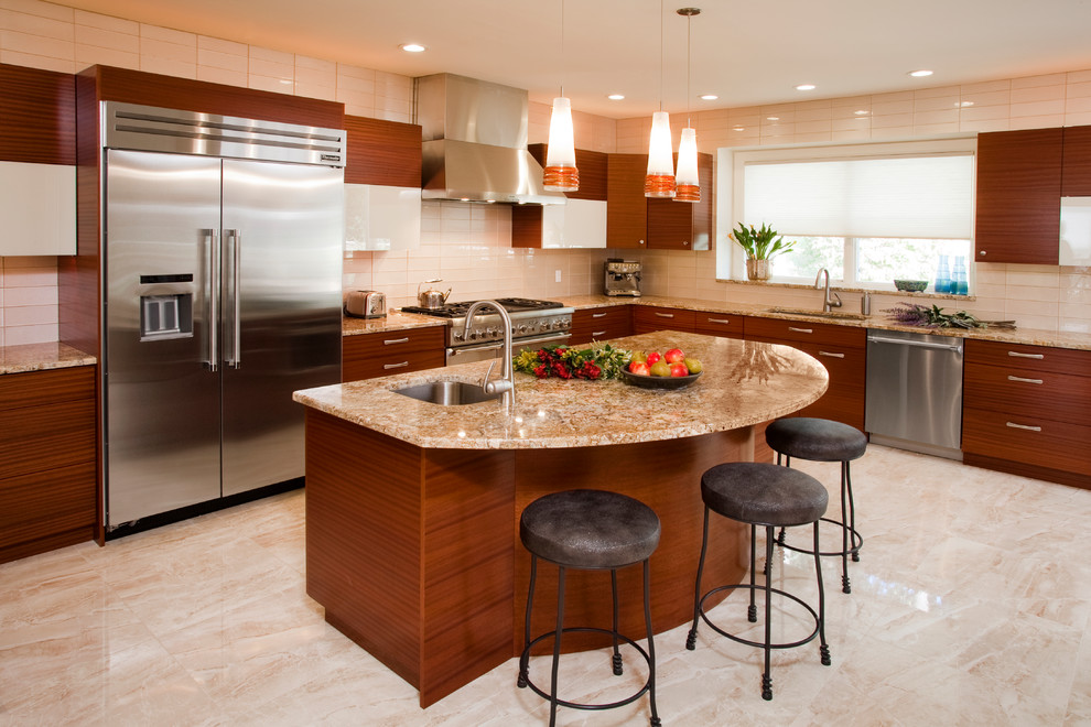 Design ideas for a contemporary l-shaped kitchen in Philadelphia with an undermount sink, flat-panel cabinets, medium wood cabinets, beige splashback, glass tile splashback, stainless steel appliances, with island, beige floor and beige benchtop.