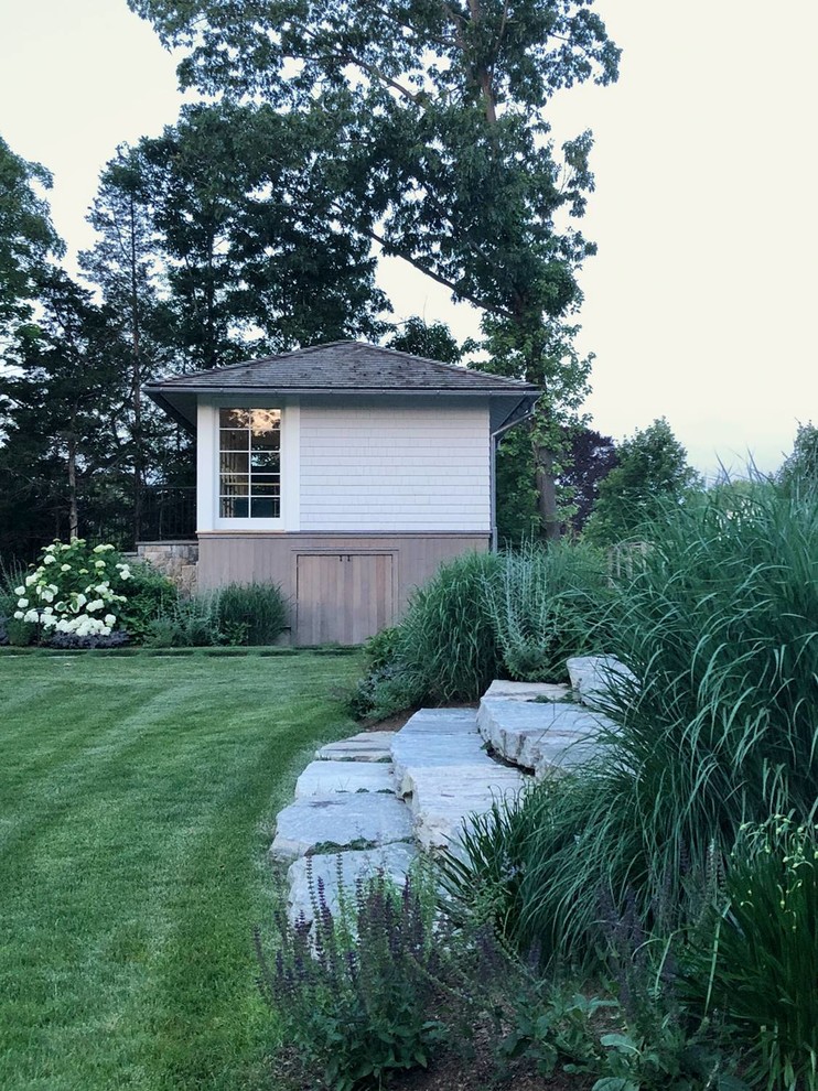 Photo of a mid-sized transitional one-storey white exterior in Other with wood siding, a hip roof and a shingle roof.