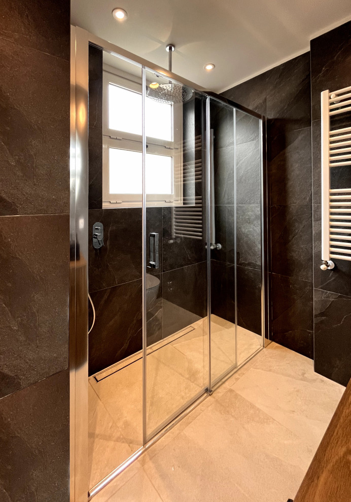This is an example of a small contemporary bathroom in Milan with raised-panel cabinets, a curbless shower, a two-piece toilet, black tile, porcelain tile, black walls, porcelain floors, a vessel sink, wood benchtops, beige floor, a sliding shower screen, brown benchtops, a single vanity and a freestanding vanity.
