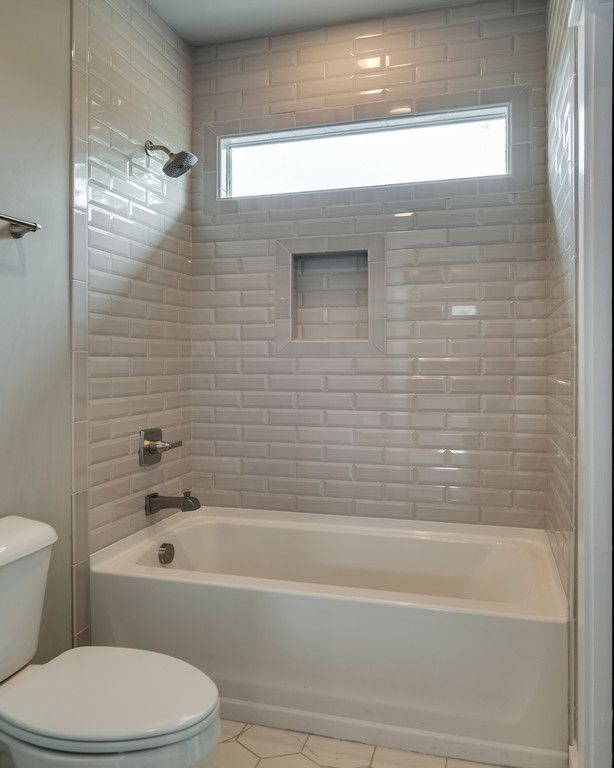 This is an example of a transitional bathroom in Nashville with a shower/bathtub combo, white tile and subway tile.