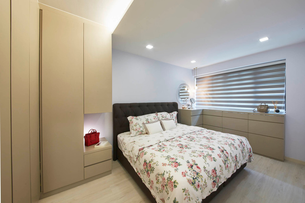 This is an example of a mid-sized contemporary master bedroom in Singapore with white walls and plywood floors.