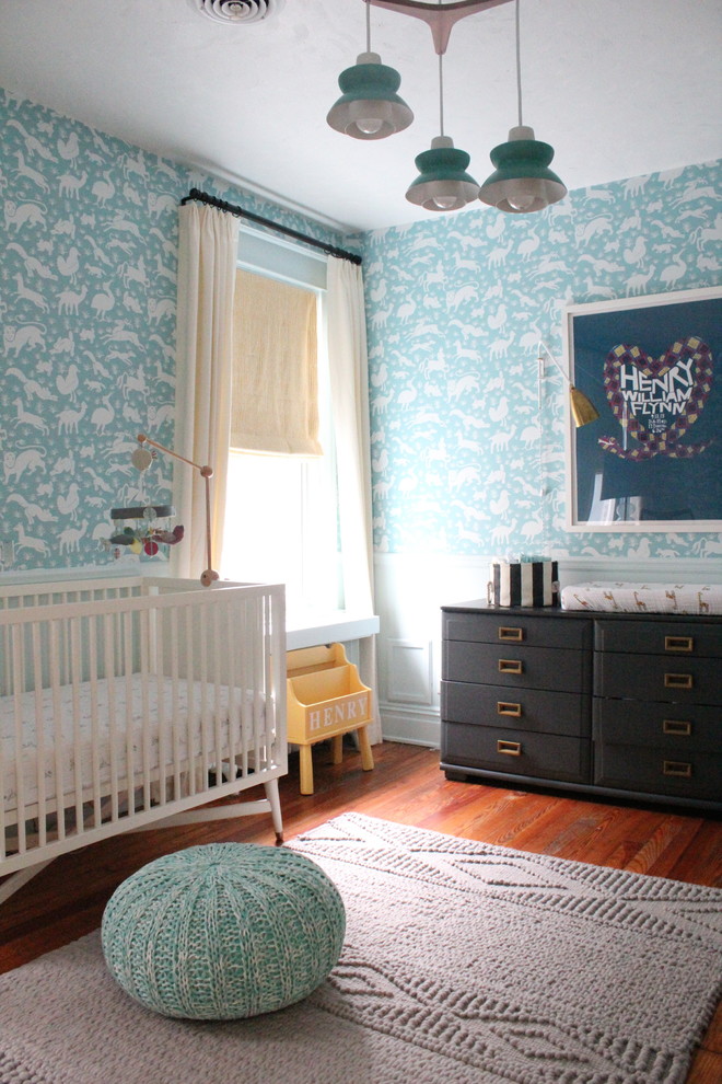 Photo of a transitional nursery for boys in Richmond with blue walls and dark hardwood floors.