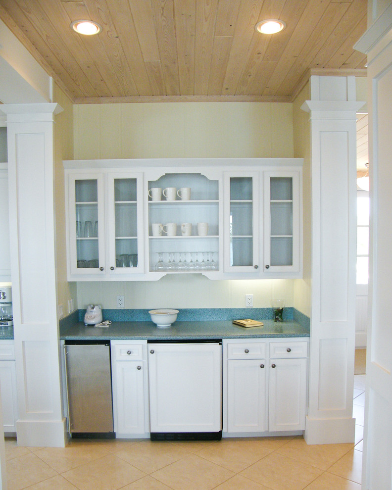 Photo of a small beach style single-wall wet bar in Other with recessed-panel cabinets, white cabinets, quartz benchtops, concrete floors, beige floor and blue benchtop.