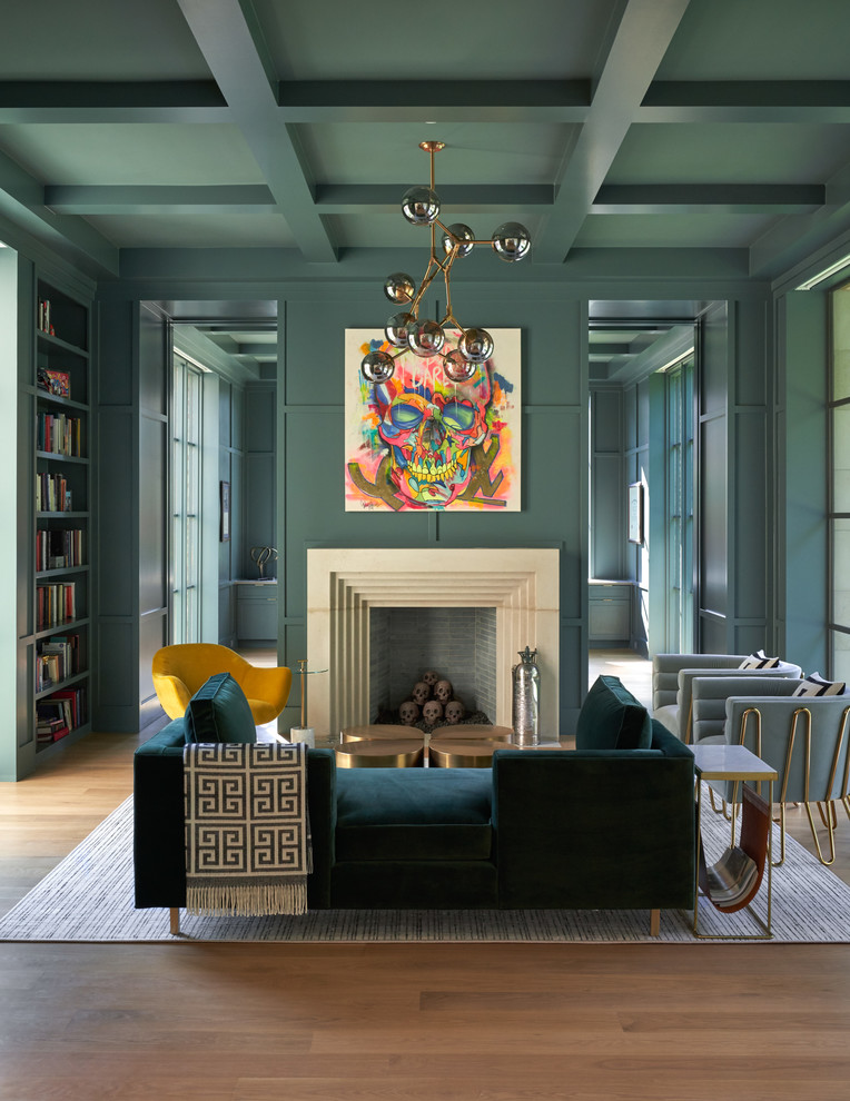 Mid-sized eclectic open concept living room in Dallas with a library, green walls, medium hardwood floors, a standard fireplace, brown floor, a stone fireplace surround and no tv.