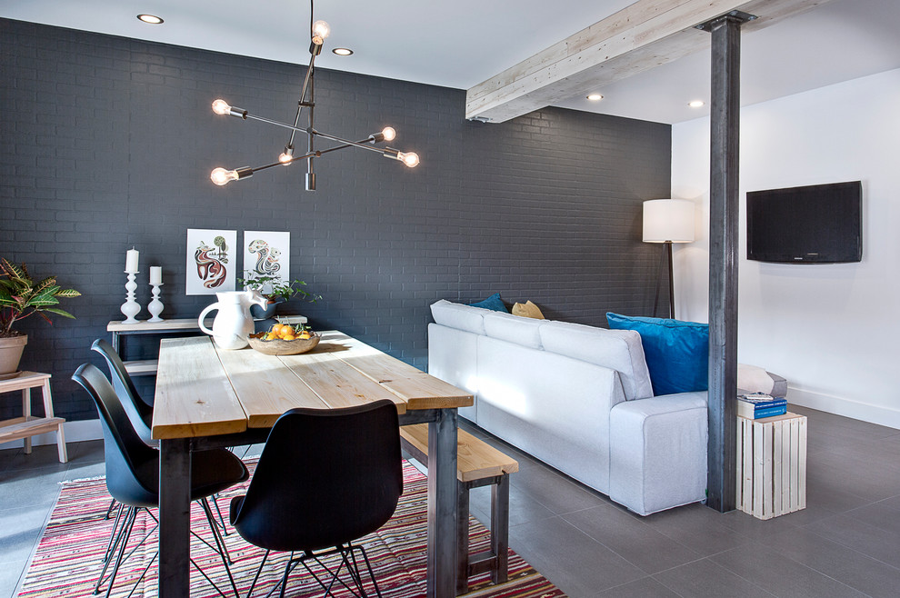 Photo of an industrial open plan dining in Montreal with grey walls.