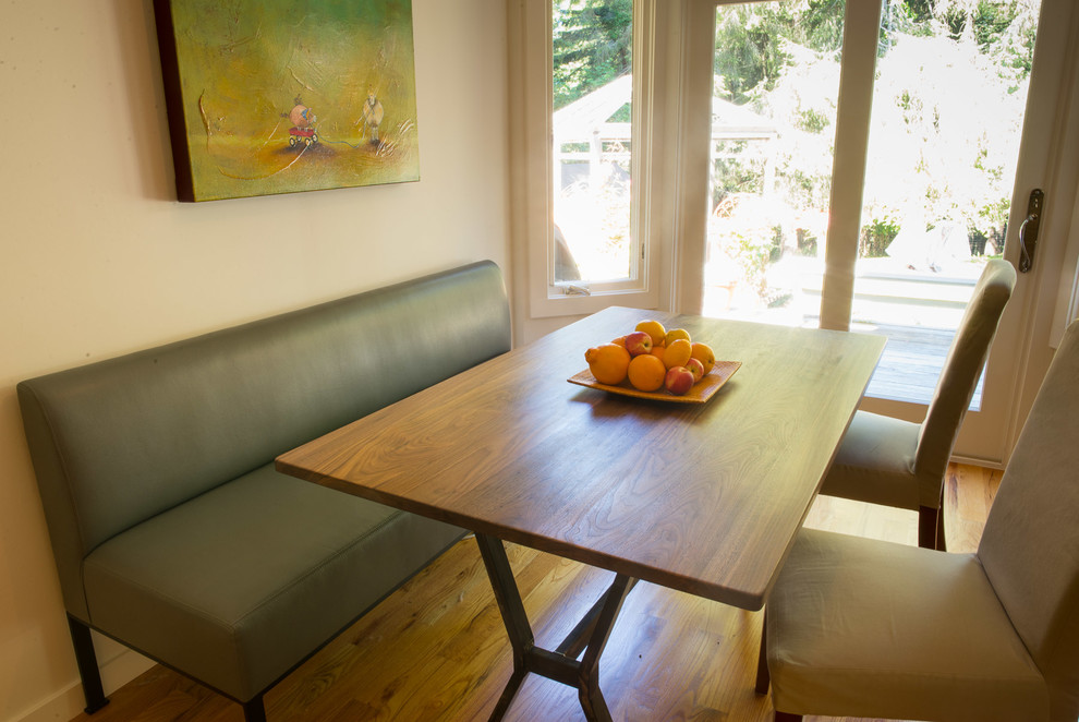 Inspiration for a mid-sized transitional u-shaped medium tone wood floor kitchen/dining room combo remodel with an undermount sink, flat-panel cabinets, medium tone wood cabinets, quartzite countertops, white backsplash, ceramic backsplash, stainless steel appliances and an island
