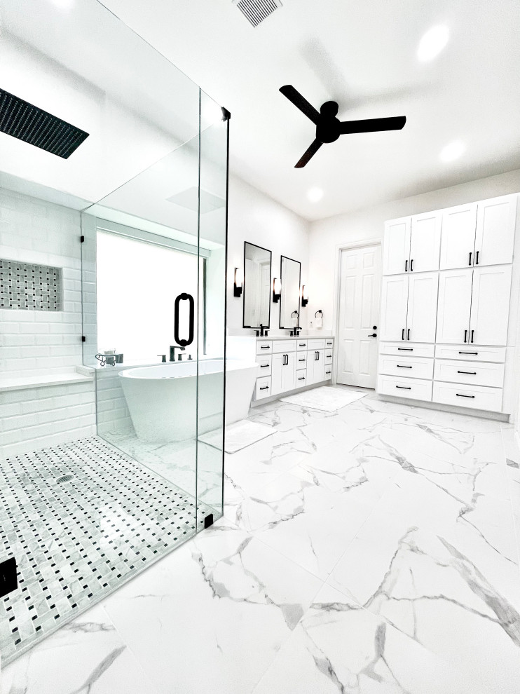 Huge minimalist master stone tile ceramic tile, multicolored floor and double-sink bathroom photo in Dallas with shaker cabinets, white cabinets, white walls, an undermount sink, quartz countertops, a hinged shower door, white countertops, a niche and a built-in vanity
