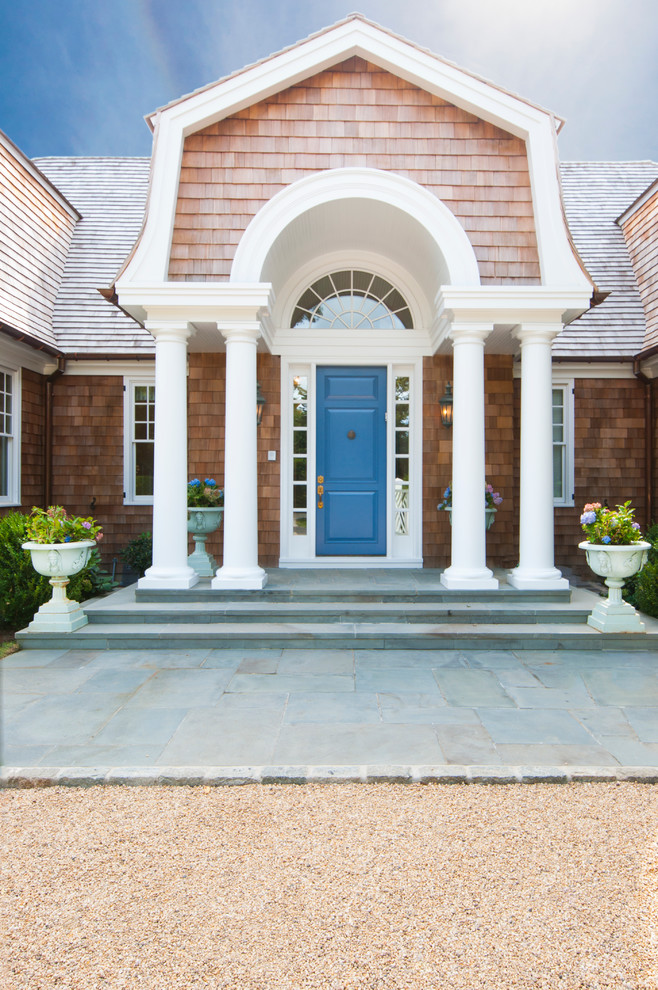 Photo of a beach style entryway in New York with a single front door and a blue front door.
