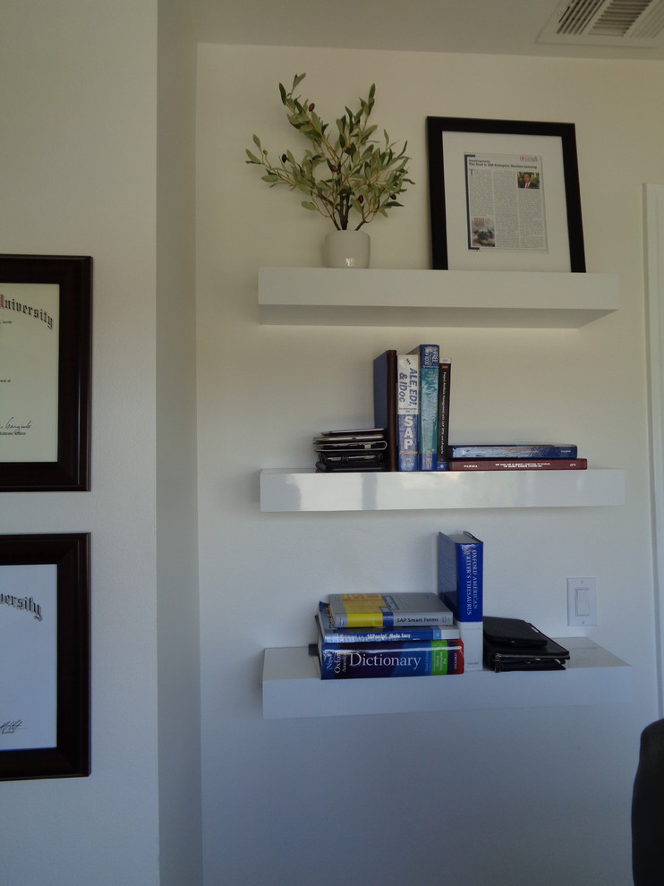 Photo of a small contemporary study room in Los Angeles with white walls, carpet, a freestanding desk and beige floor.