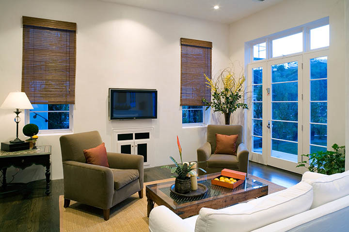 This is an example of a mid-sized transitional formal enclosed living room in Los Angeles with white walls, dark hardwood floors and a wall-mounted tv.