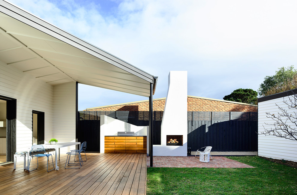 Mid-sized contemporary courtyard patio in Melbourne with a fire feature, decking and a pergola.