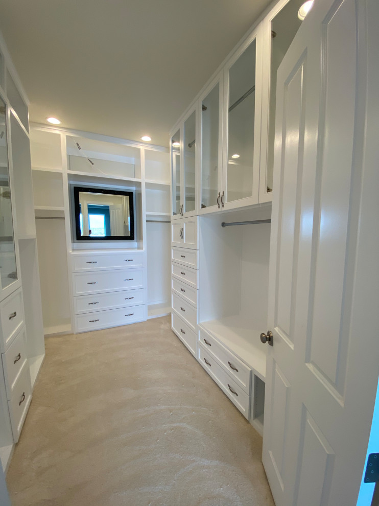 Design ideas for an expansive modern gender-neutral walk-in wardrobe in Other with shaker cabinets, white cabinets, carpet and beige floor.