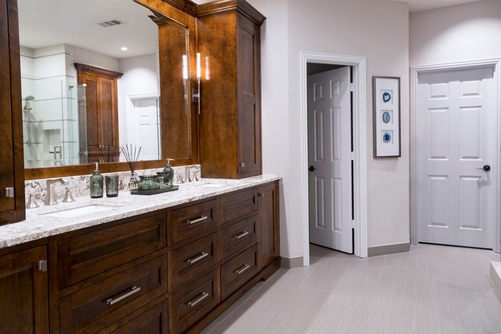 Mid-sized transitional master bathroom in Dallas with recessed-panel cabinets, dark wood cabinets, an undermount tub, a corner shower, beige tile, porcelain tile, porcelain floors, an undermount sink and granite benchtops.