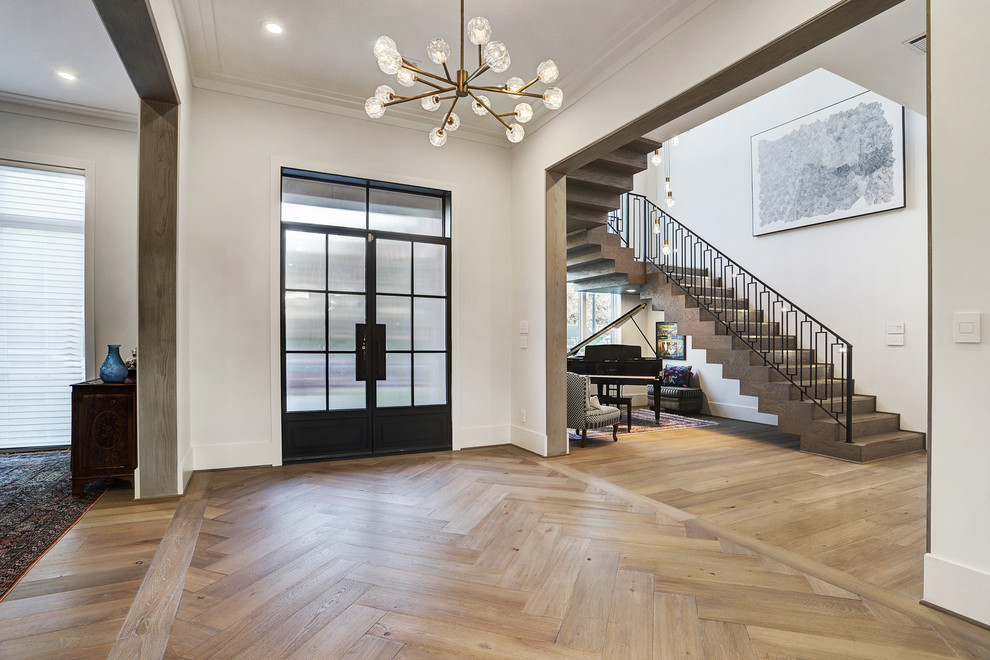 Photo of an expansive transitional front door in Houston with white walls, light hardwood floors, a double front door, a black front door and white floor.
