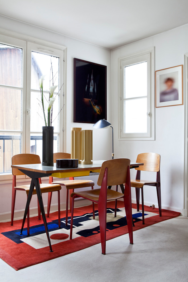 Idée de décoration pour une salle à manger design avec un mur blanc et éclairage.